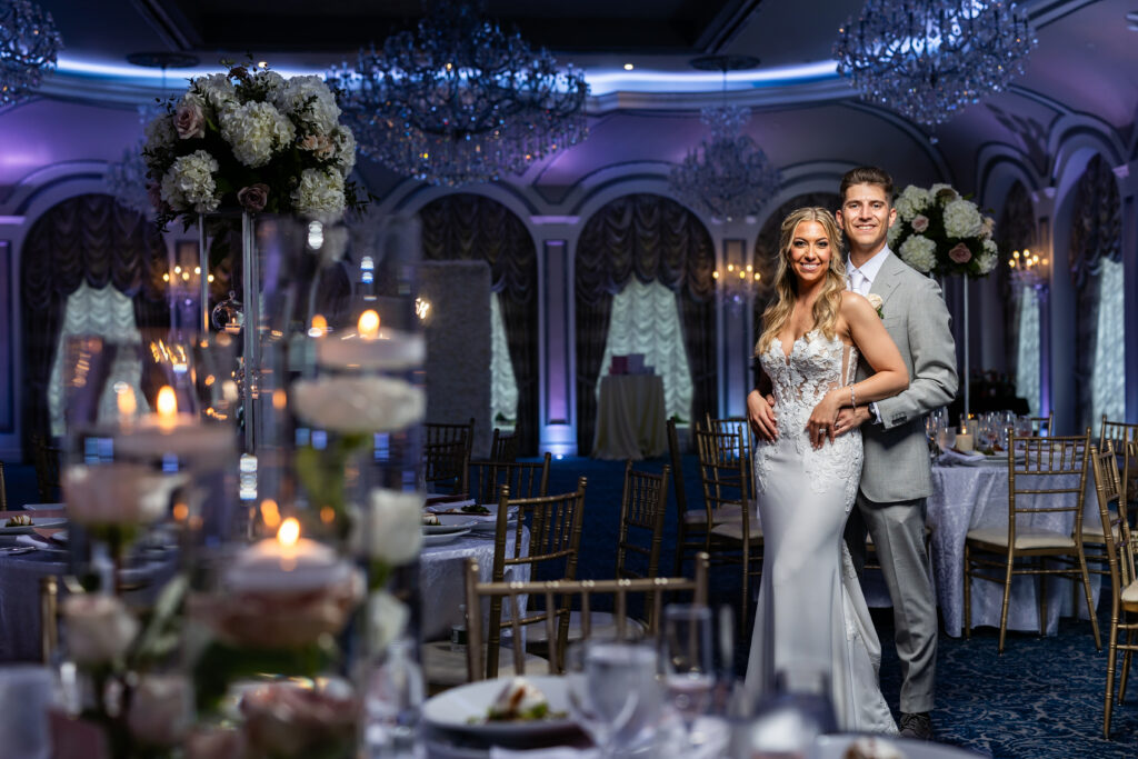 A bride and groom, captured by New Jersey Wedding Photographer Jarot Bocanegra, pose for a photo at their wedding reception.