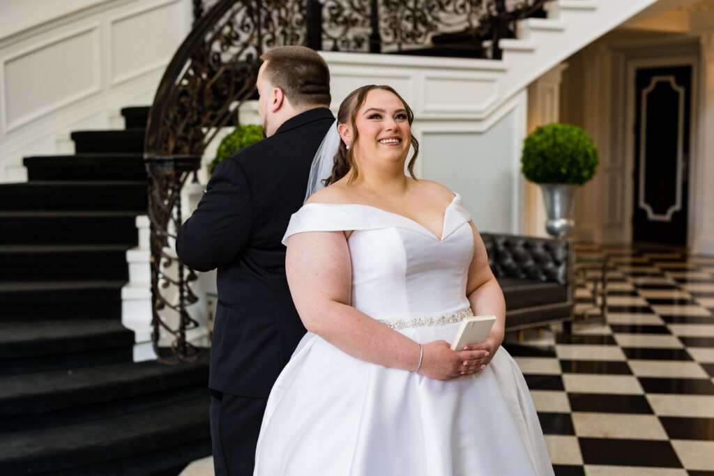 A bride and groom, captured by New Jersey Wedding Photographer Jarot Bocanegra, standing in front of a staircase.