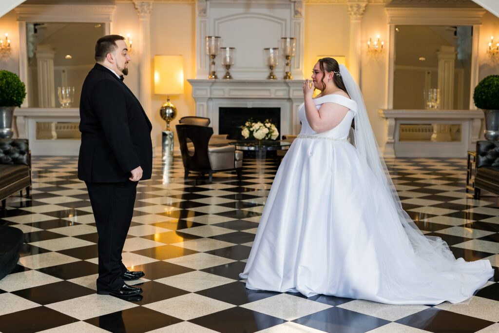 A bride and groom, captured by New Jersey Wedding Photographer Jarot Bocanegra, standing in the lobby of a hotel.