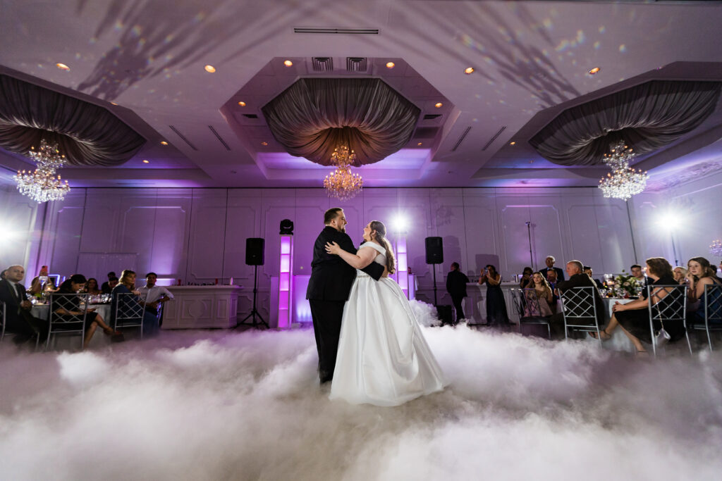 A bride and groom, captured by New Jersey Wedding Photographer Jarot Bocanegra, dance in a cloud of smoke.
