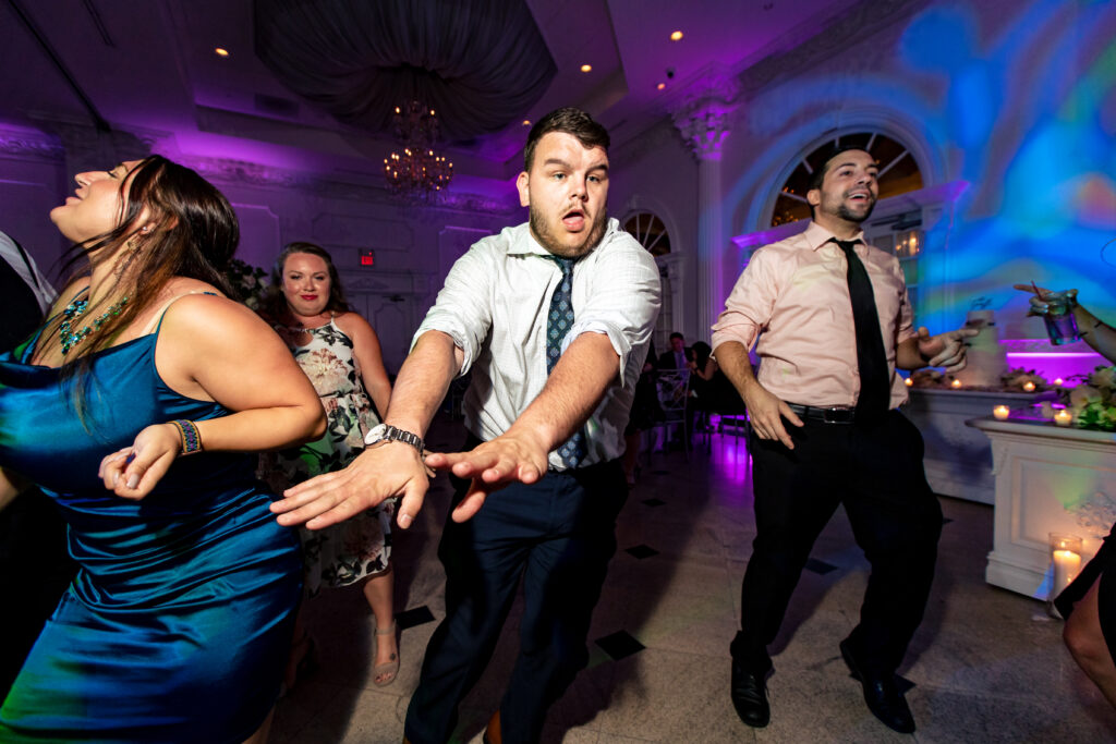 A group of people dancing at a wedding reception, captured by New Jersey Wedding Photographer Jarot Bocanegra.