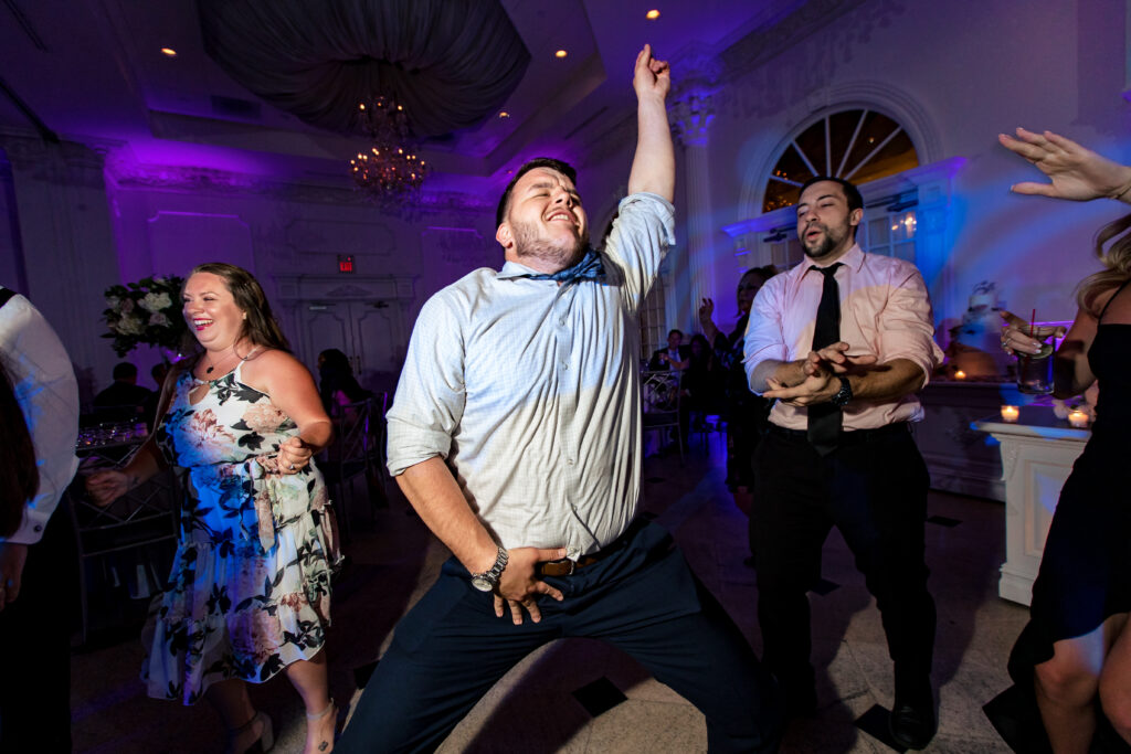 A man is dancing at a wedding reception with his moves captured by New Jersey Wedding Photographer Jarot Bocanegra.