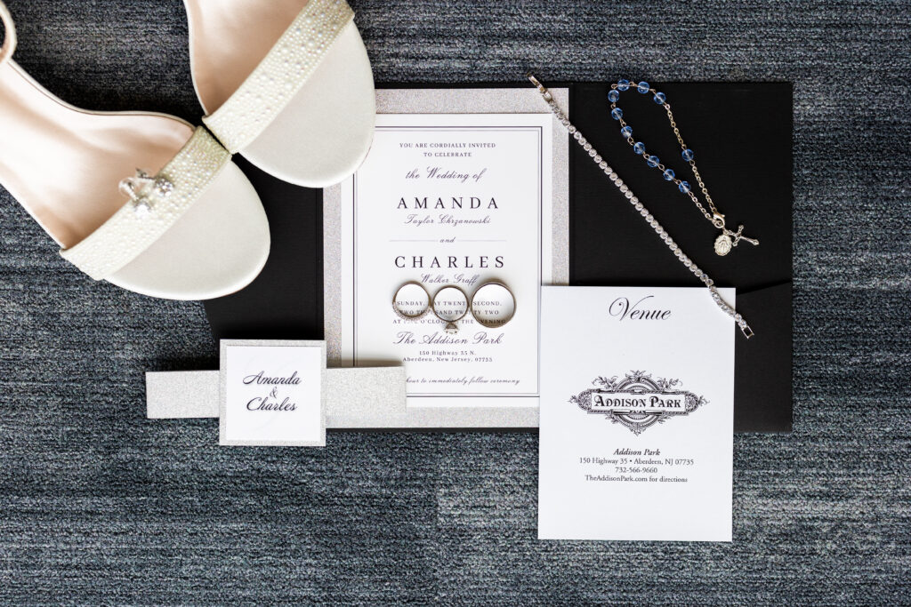 A New Jersey Wedding Photographer, Jarot Bocanegra, beautifully captures a wedding invitation, wedding shoes, and a wedding ring.