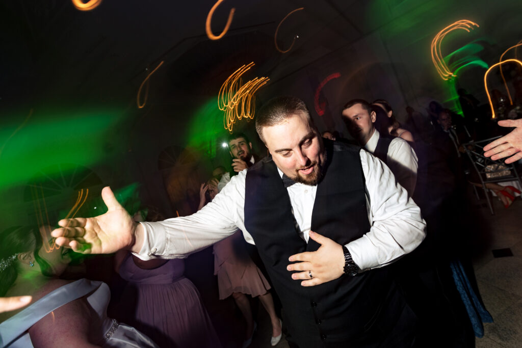 A man dancing on the dance floor at a wedding, captured by New Jersey Wedding Photographer Jarot Bocanegra.