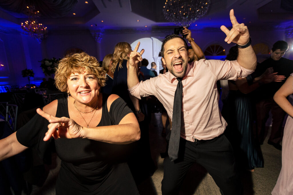 A man and woman captured by New Jersey Wedding Photographer Jarot Bocanegra, dancing at a wedding reception.