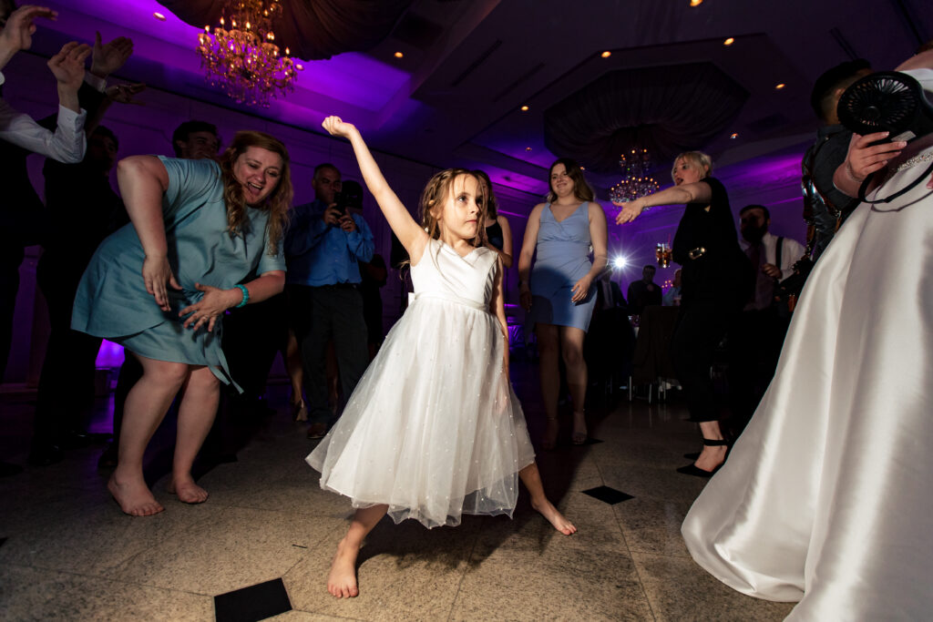 A little girl dancing on the dance floor at a wedding, captured by New Jersey Wedding Photographer Jarot Bocanegra.