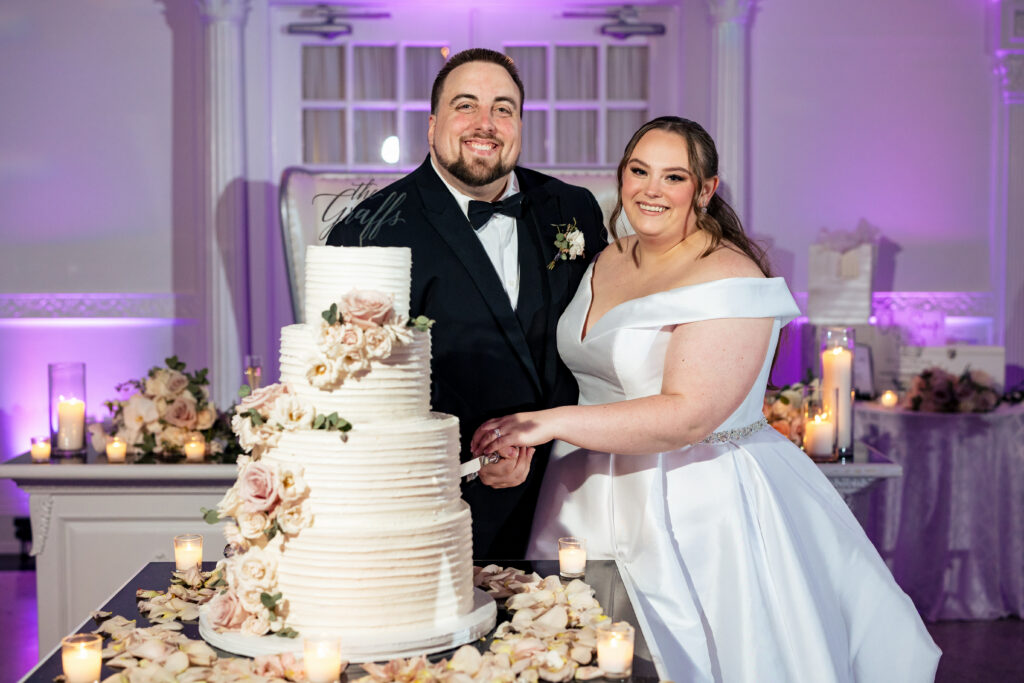 A bride and groom cutting their wedding cake, captured by New Jersey Wedding Photographer Jarot Bocanegra.