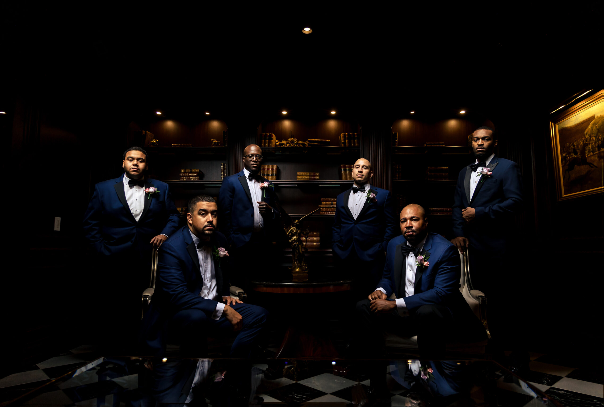 Intriguing creative portraits of the groom and groomsmen captured in the elegant library of the Park Chateau Estate and Gardens. The sophisticated setting and composition were artfully photographed by North Jersey wedding photographer Jarot Bocanegra