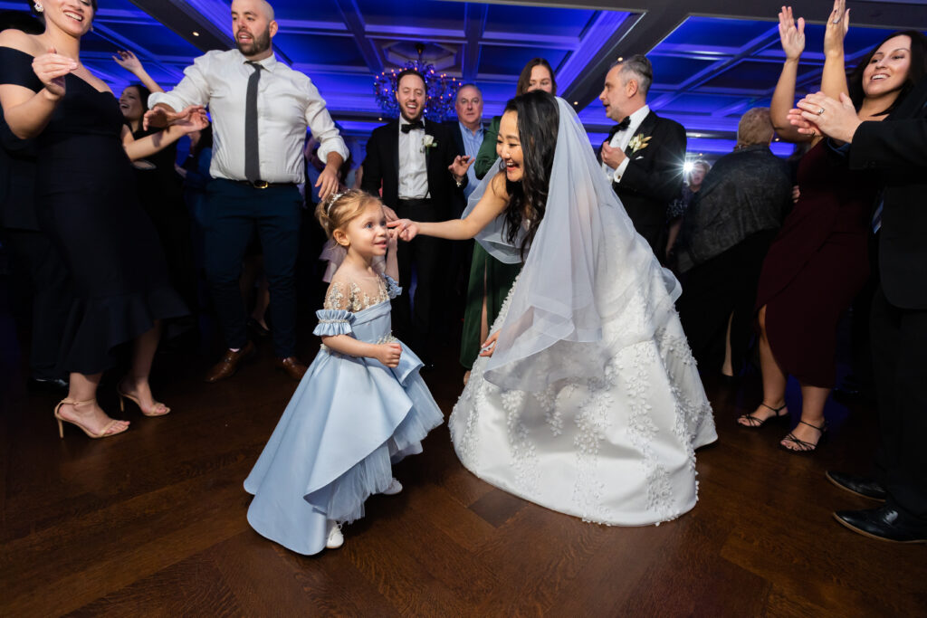 A little girl dancing on the dance floor at a wedding reception, captured by New Jersey Wedding Photographer Jarot Bocanegra.