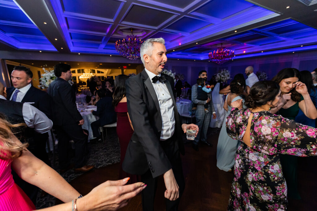 A group of people dancing at a wedding reception, captured by New Jersey Wedding Photographer Jarot Bocanegra.