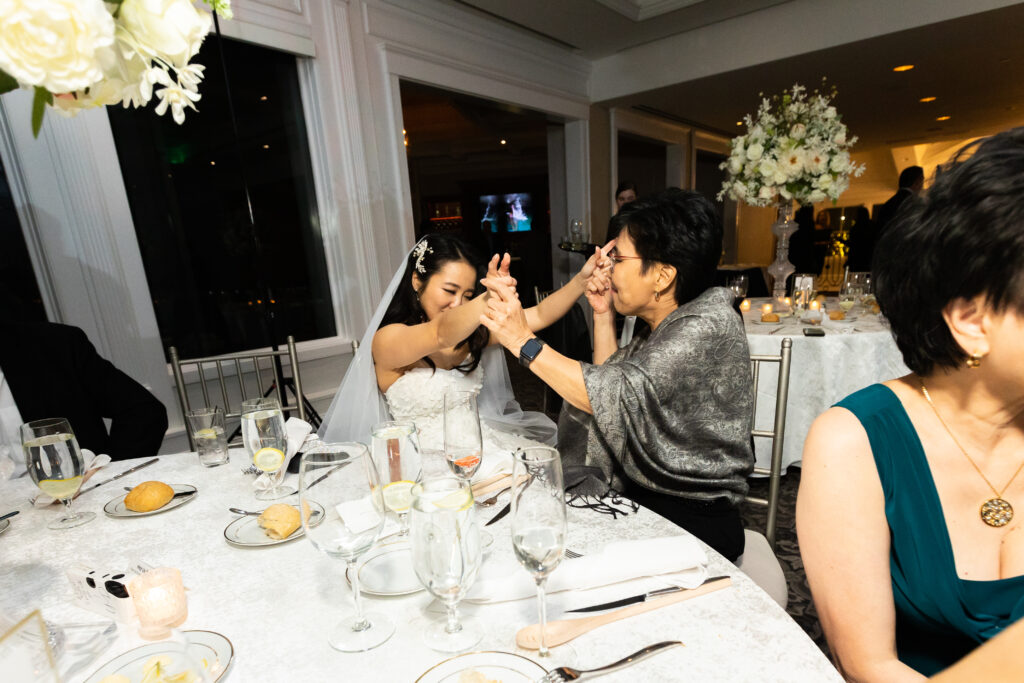 A bride and groom captured by New Jersey Wedding Photographer Jarot Bocanegra, toasting at a wedding reception.