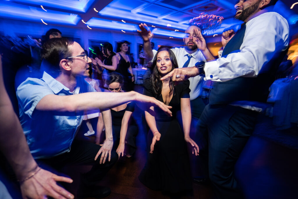 A group of people dancing at a wedding reception captured by New Jersey Wedding Photographer Jarot Bocanegra.