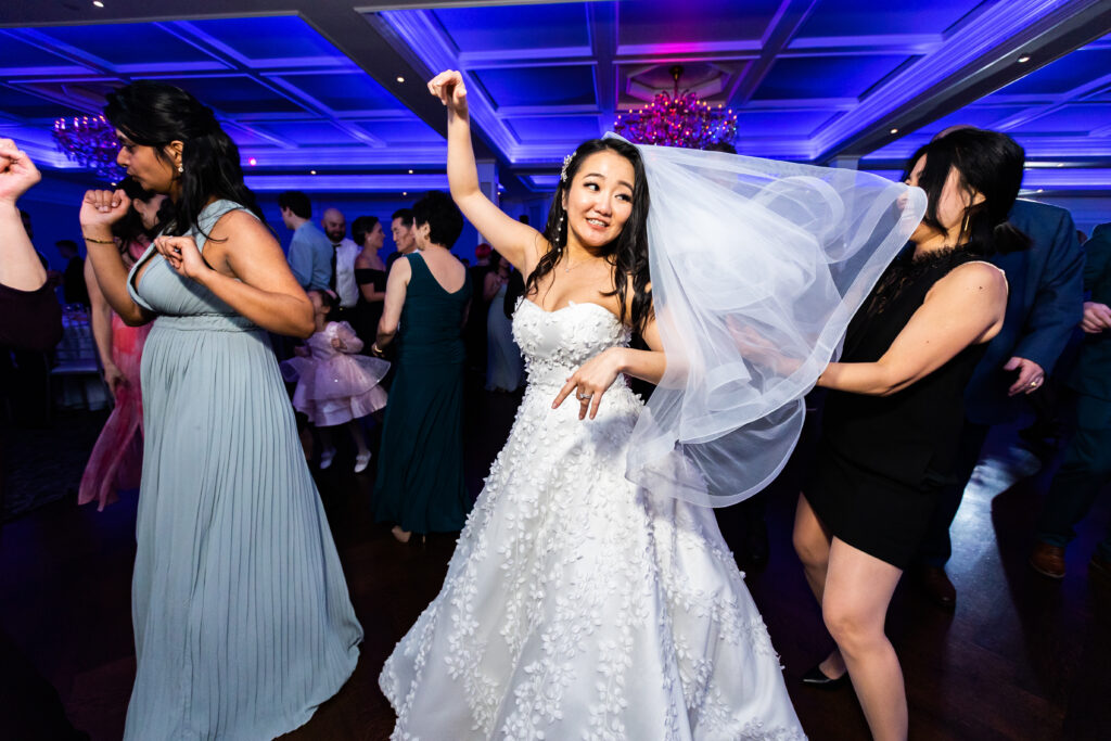 A bride dancing on the dance floor at a wedding reception, captured by New Jersey Wedding Photographer Jarot Bocanegra.