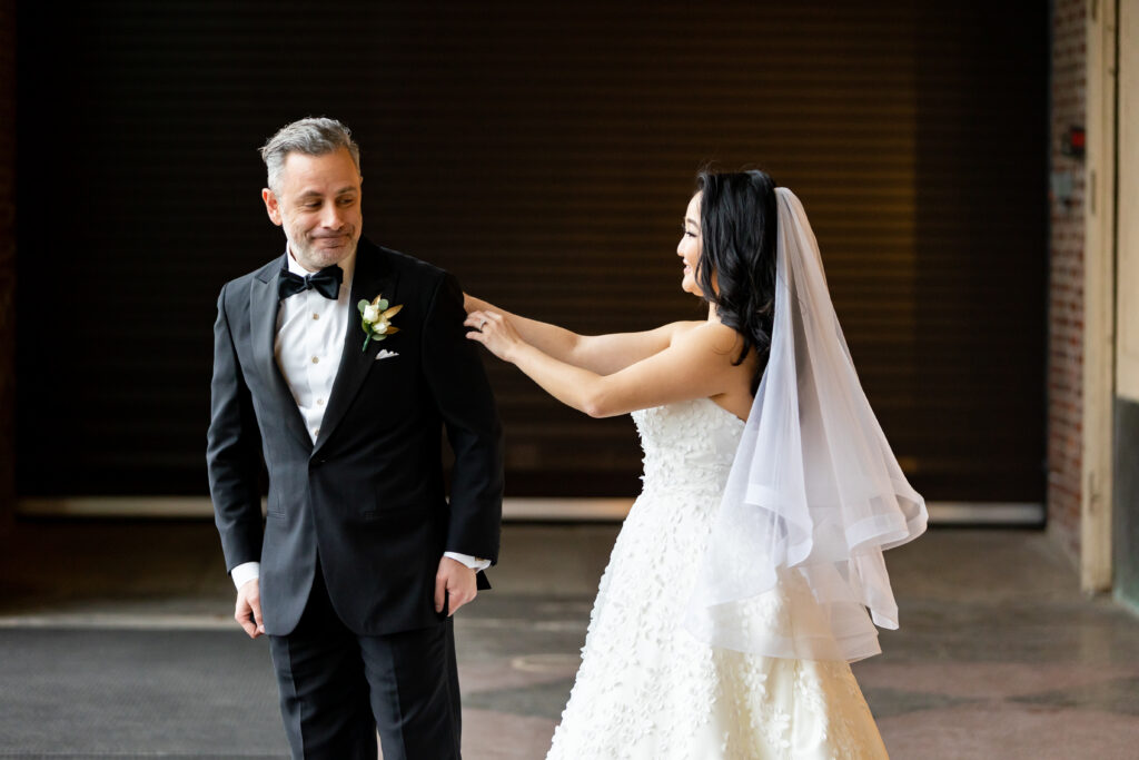 A bride and groom in tuxedos, captured by New Jersey Wedding Photographer Jarot Bocanegra.