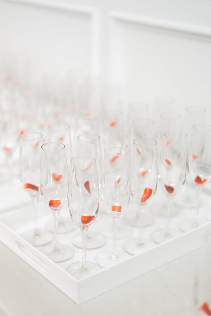 A tray of wine glasses with orange leaves on it, captured by New Jersey Wedding Photographer Jarot Bocanegra.