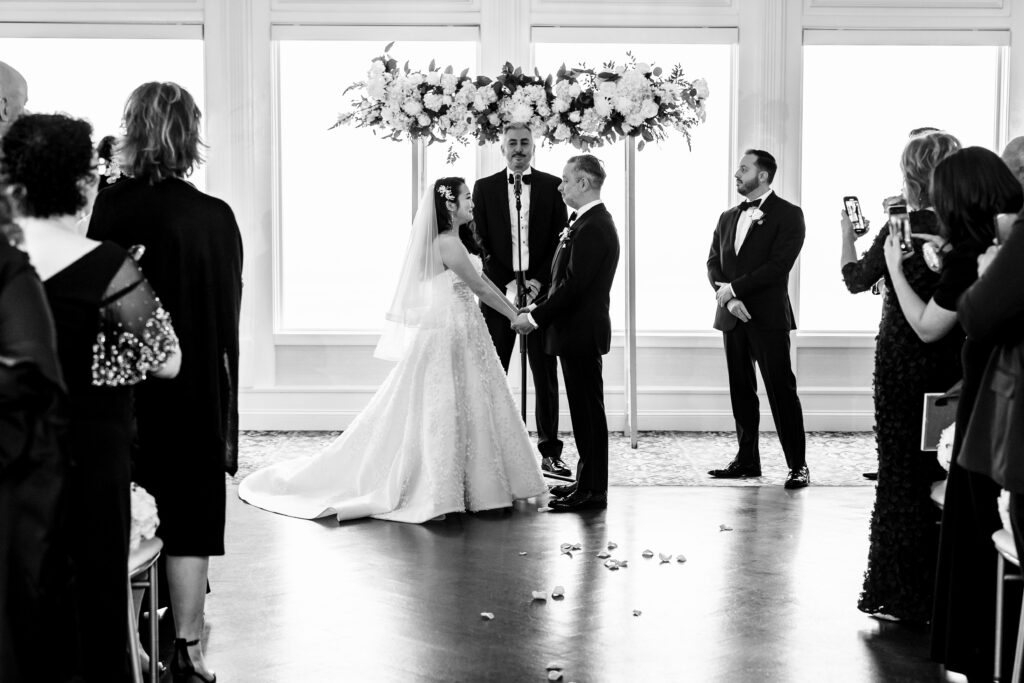 A black and white photo of a wedding ceremony, captured by New Jersey Wedding Photographer.