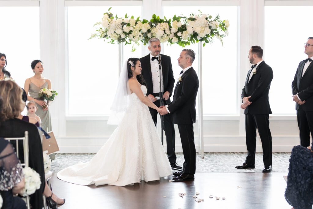 A bride and groom exchange vows, captured by New Jersey Wedding Photographer Jarot Bocanegra, in a wedding ceremony.