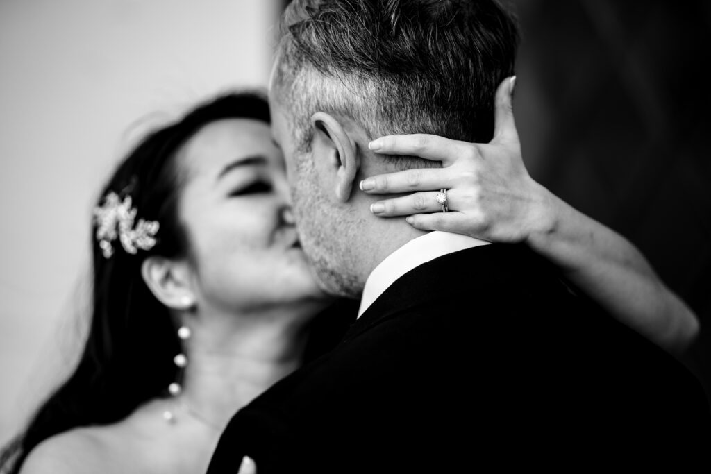 A stunning black and white photo of a bride and groom captured by New Jersey Wedding Photographer Jarot Bocanegra, passionately kissing on their special day.