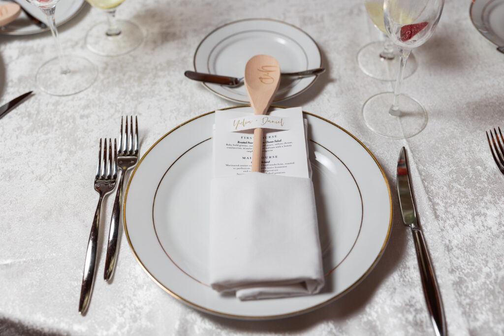 A white plate with a wooden spoon on it, captured by New Jersey Wedding Photographer Jarot Bocanegra.
