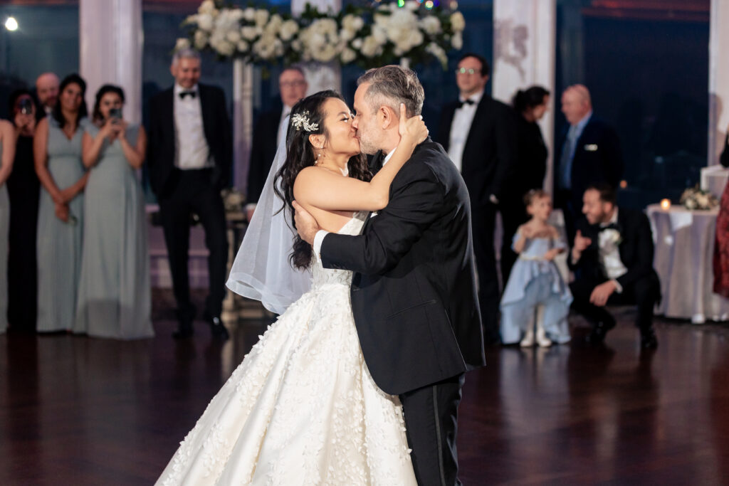 A bride and groom share their first dance at a wedding reception, captured by New Jersey Wedding Photographer Jarot Bocanegra.