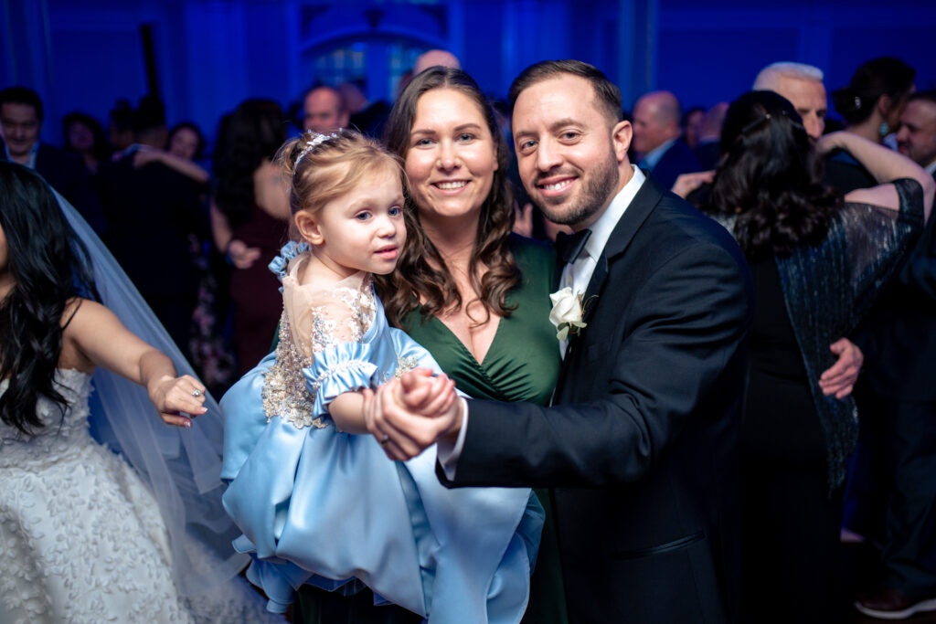 A bride and groom dancing with their daughter at a wedding reception, captured by New Jersey Wedding Photographer Jarot Bocanegra.