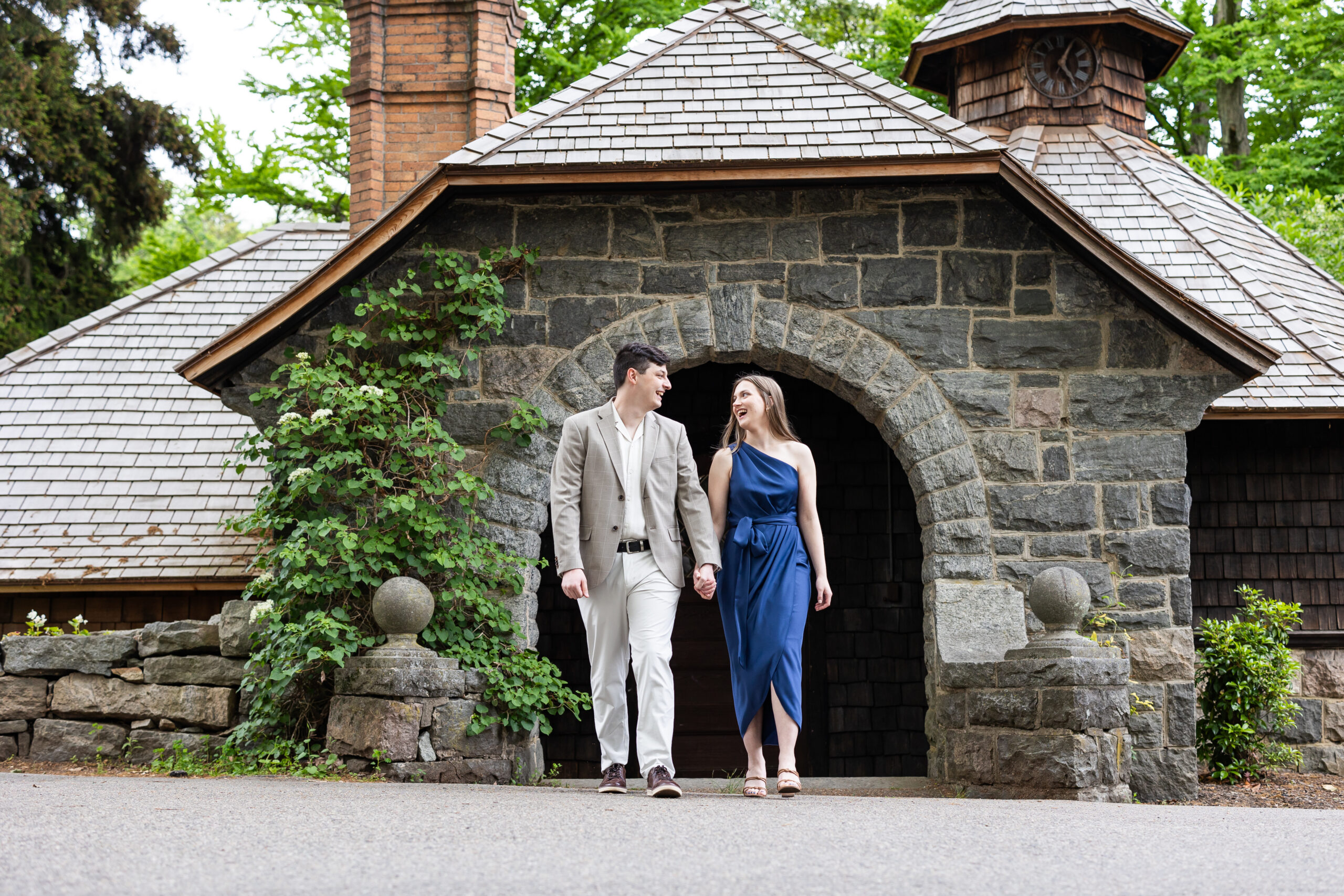 A couple captured by New Jersey Wedding Photographer Jarot Bocanegra standing in front of a stone building.