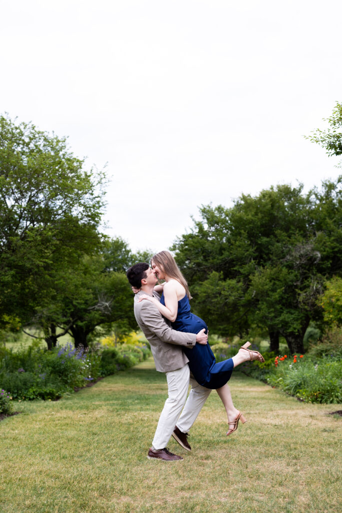 A man and woman hugging in a garden, captured by New Jersey Wedding Photographer Jarot Bocanegra.
