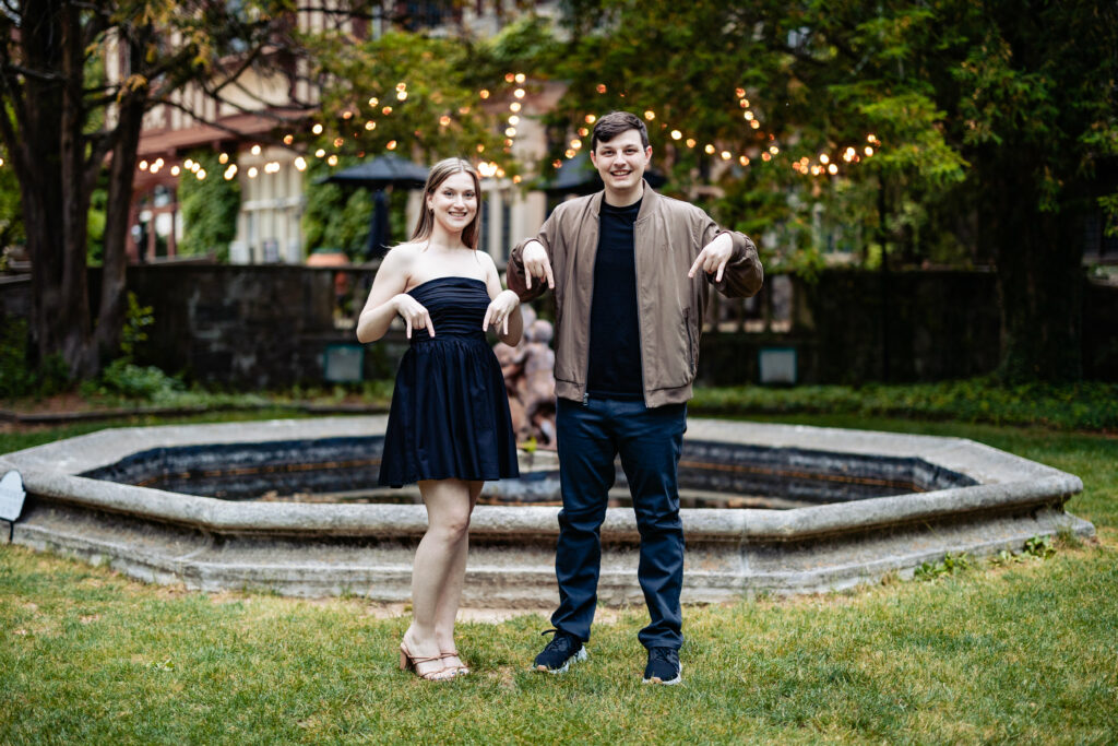 A couple, captured by New Jersey Wedding Photographer Jarot Bocanegra, standing in front of a fountain.