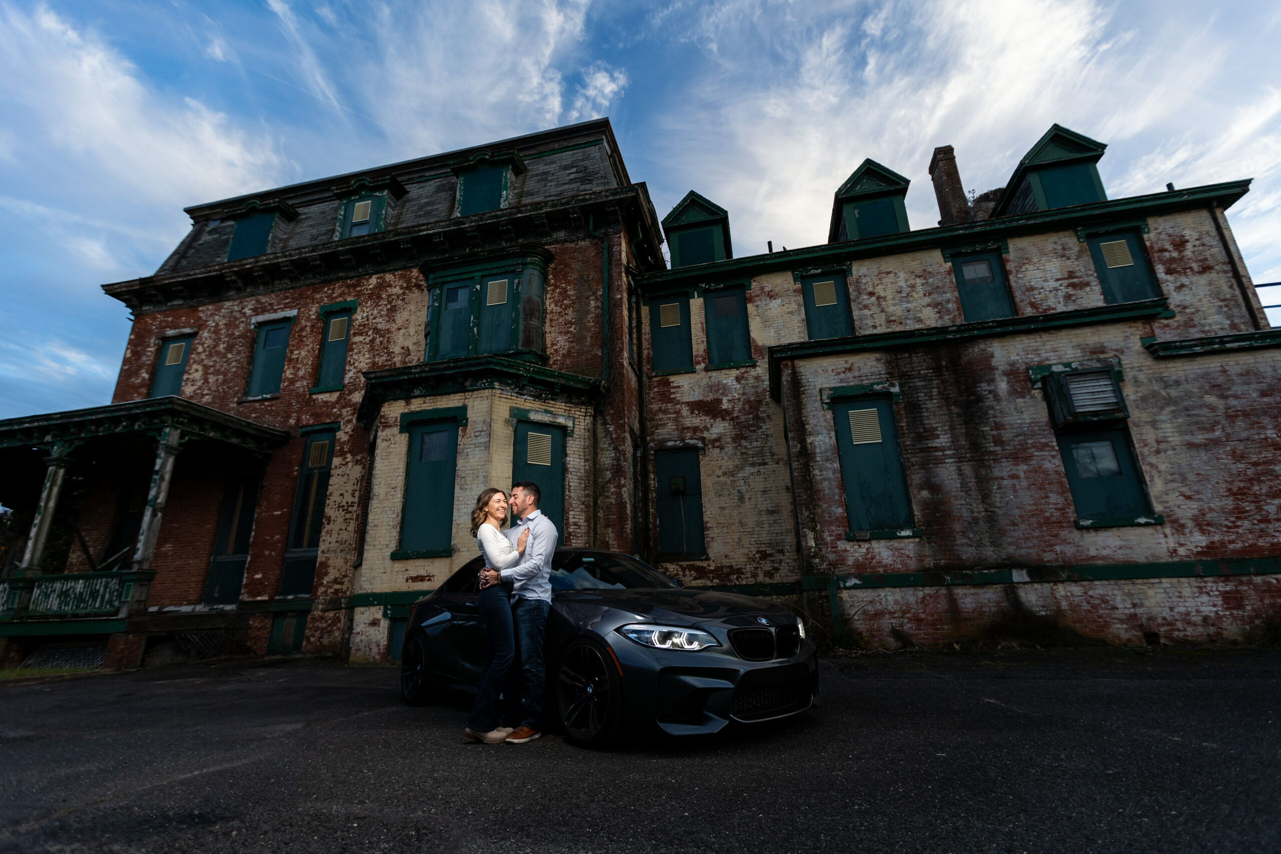 A couple captured by New Jersey Wedding Photographer Jarot Bocanegra poses in front of an old mansion.