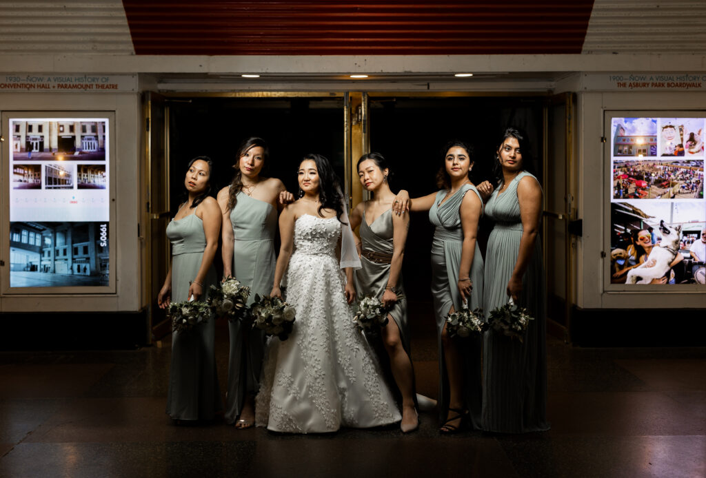 A bride and her bridesmaids captured by New Jersey Wedding Photographer Jarot Bocanegra in front of a train station.