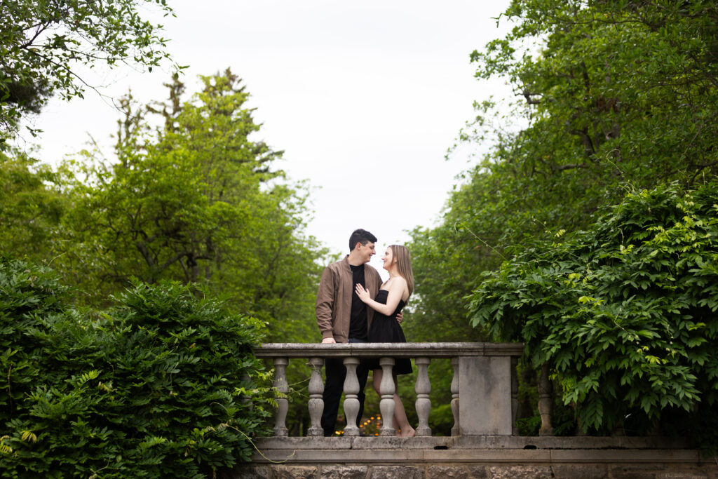 This beautiful moment of an engaged couple standing on a bridge at New Jersey Botanical Garden was captured by New Jersey Wedding Photographer Jarot Bocanegra.
