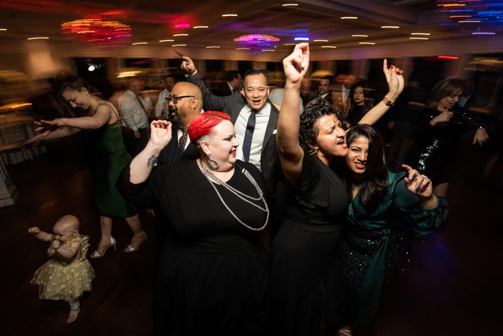 A group of people dancing during a wedding at The Mill Lakeside Manor, captured by New Jersey Wedding Photographer Jarot Bocanegra