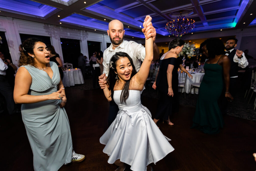 A bride and groom captured by New Jersey Wedding Photographer Jarot Bocanegra, dancing at a wedding reception.