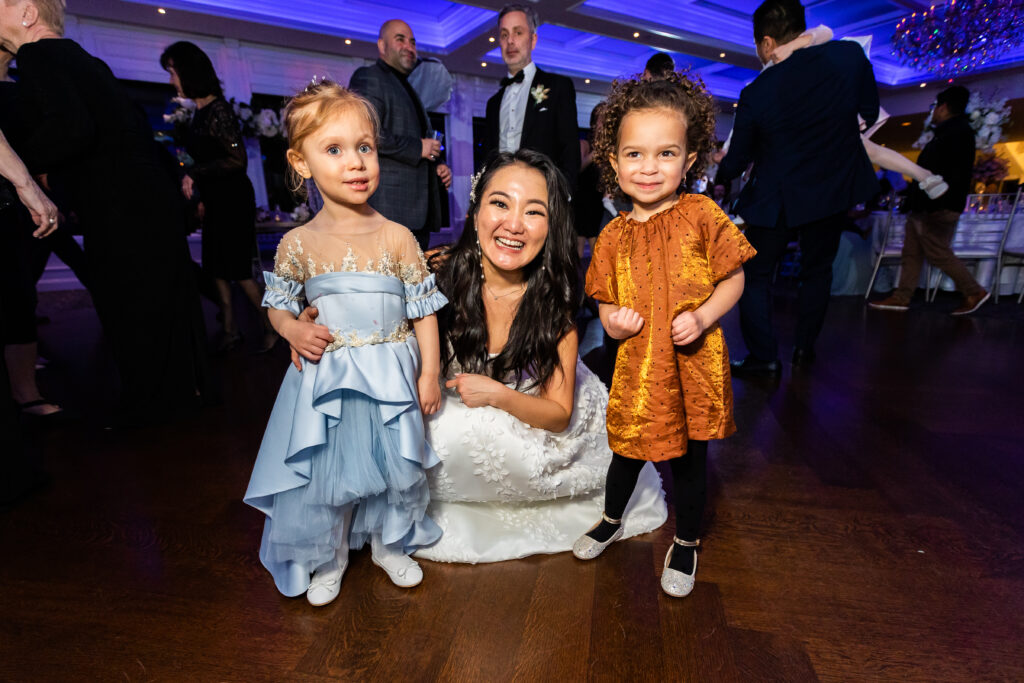 A bride and her children, captured by New Jersey Wedding Photographer Jarot Bocanegra, pose for a photo at a wedding reception.