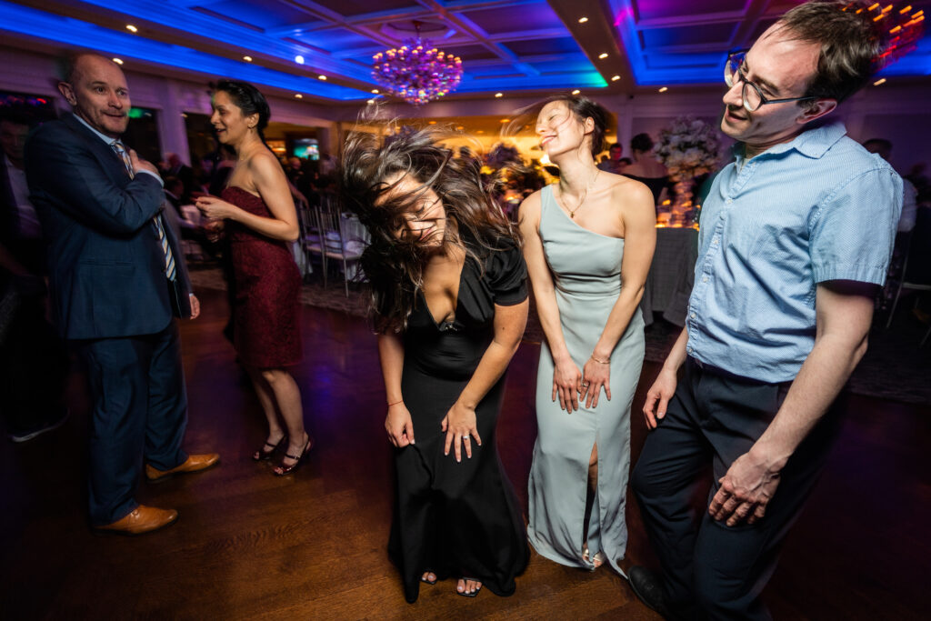 A group of people captured by New Jersey Wedding Photographer Jarot Bocanegra, dancing at a wedding reception.