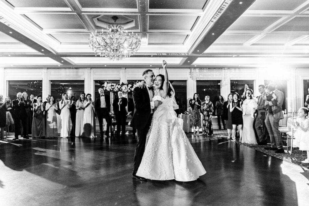 Captured by New Jersey Wedding Photographer Jarot Bocanegra, a bride and groom share their first dance in a ballroom.